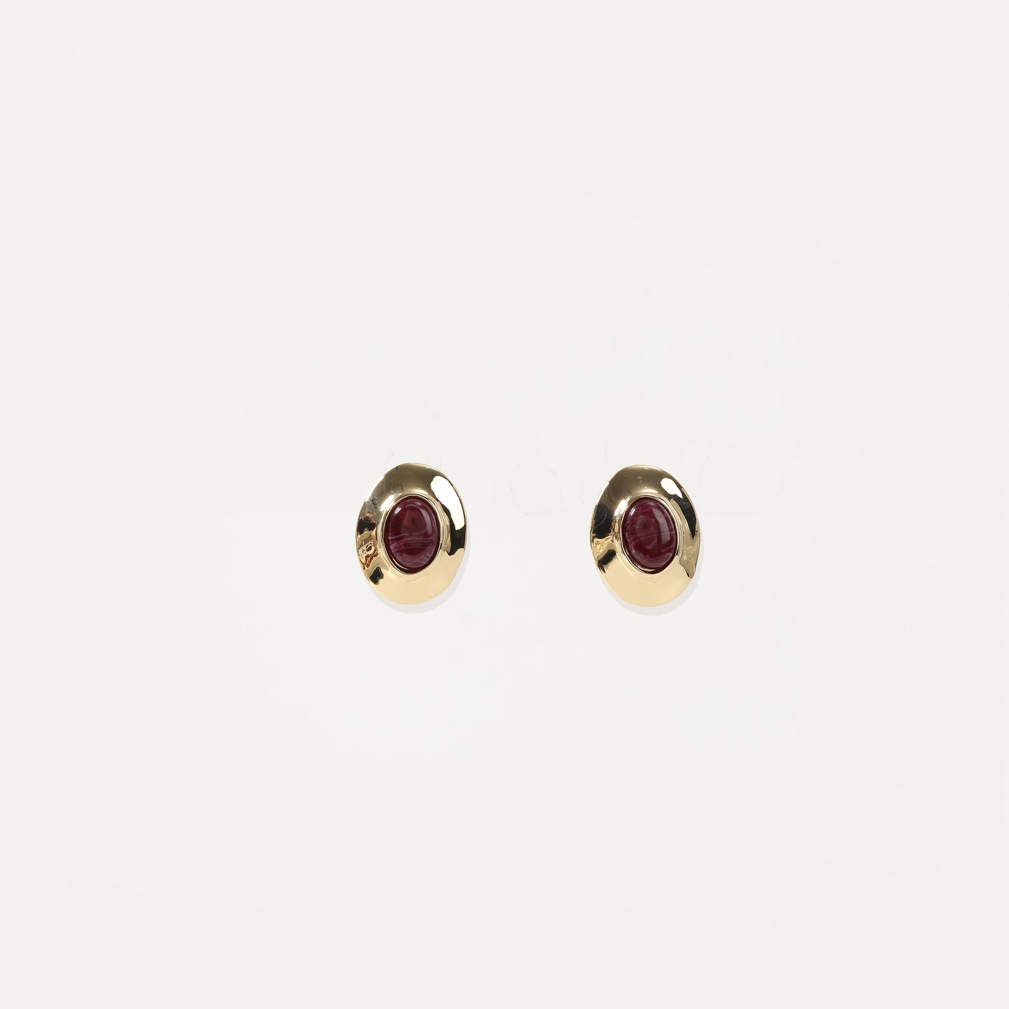 Gold-framed deep red oval stud earrings