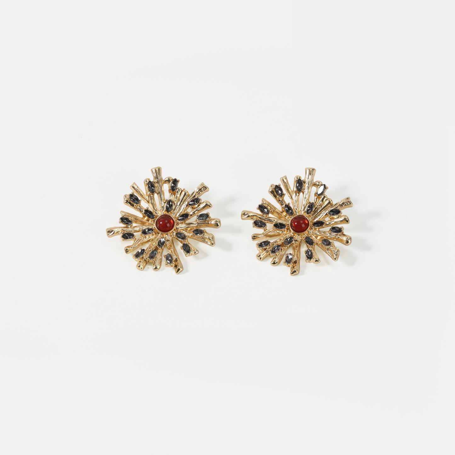 Gold-tone sunburst with red and black crystal stud earrings