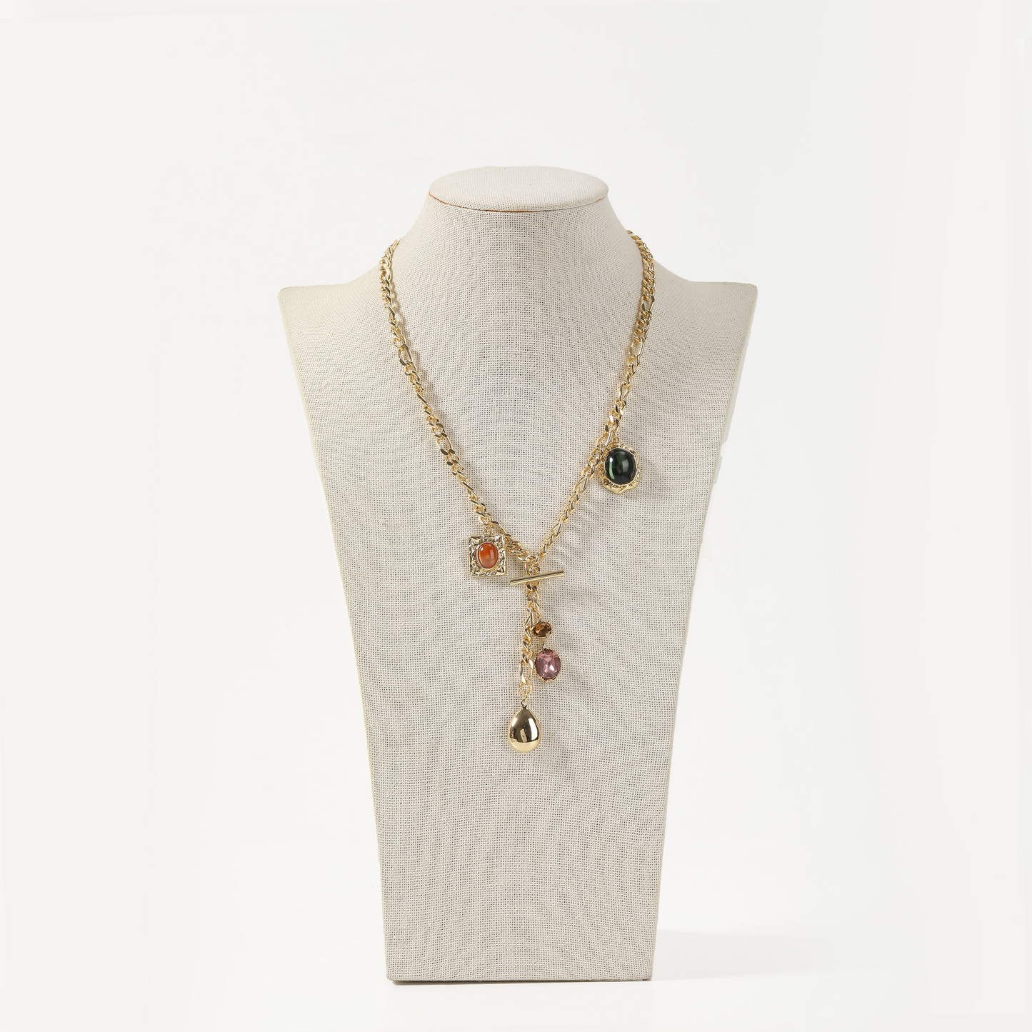 Gold curb chain necklace with mixed gemstone charms and toggle clasp