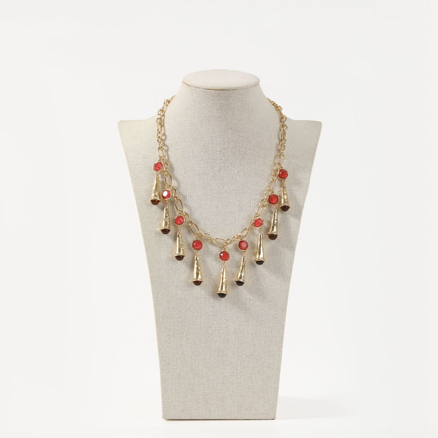 Gold statement necklace with red agate accents and cone-shaped metal fringe