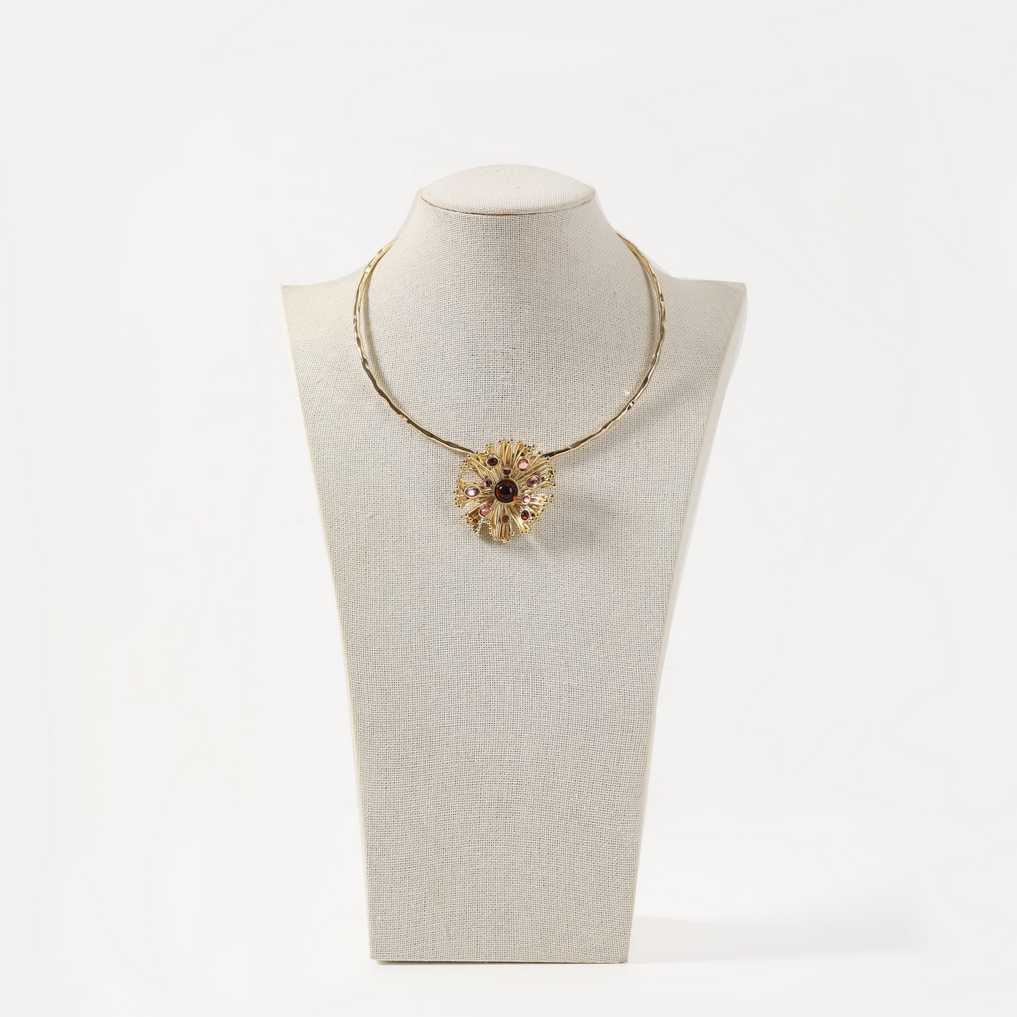 Gold torque necklace with sunburst multi-tone gemstone pendant