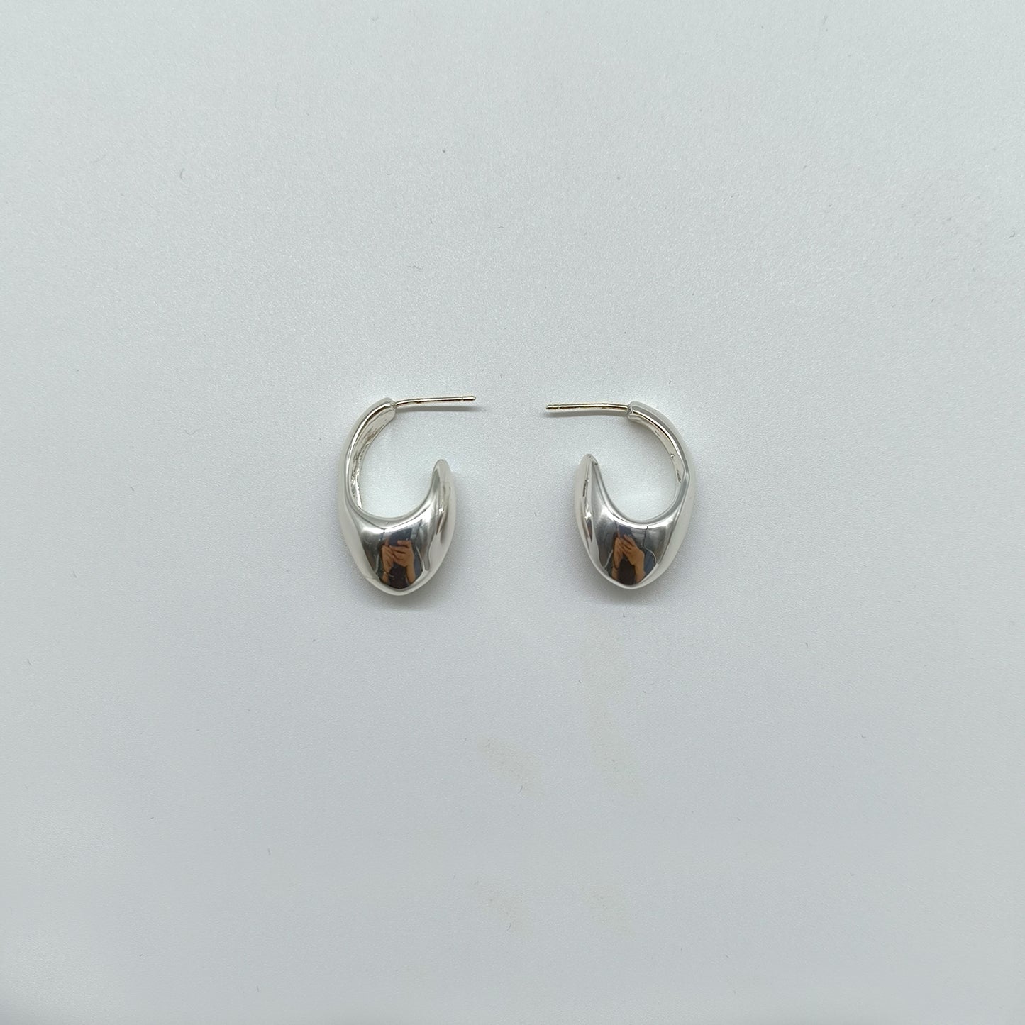 Chunky Silver Hoop Earrings with Organic Curve – Modern Statement Style