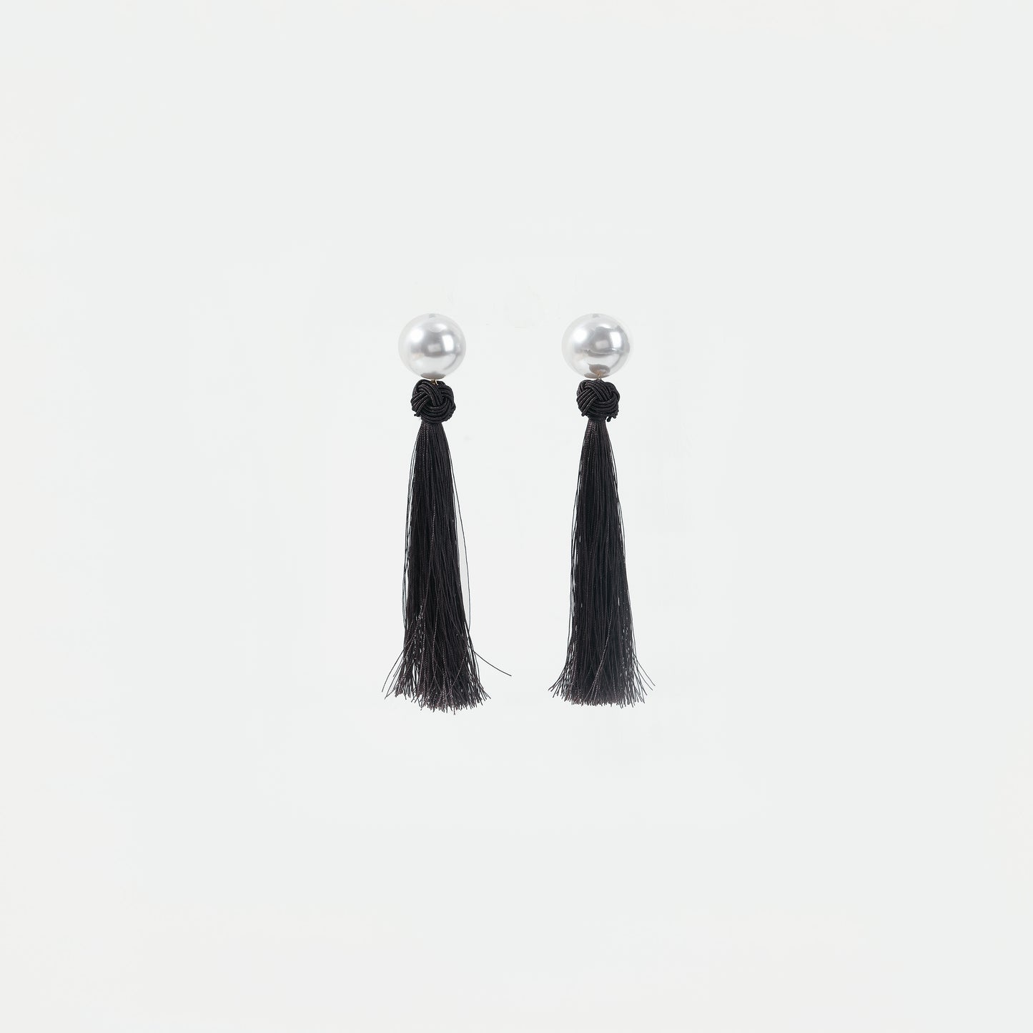 White pearl with black knotted tassel drop earrings