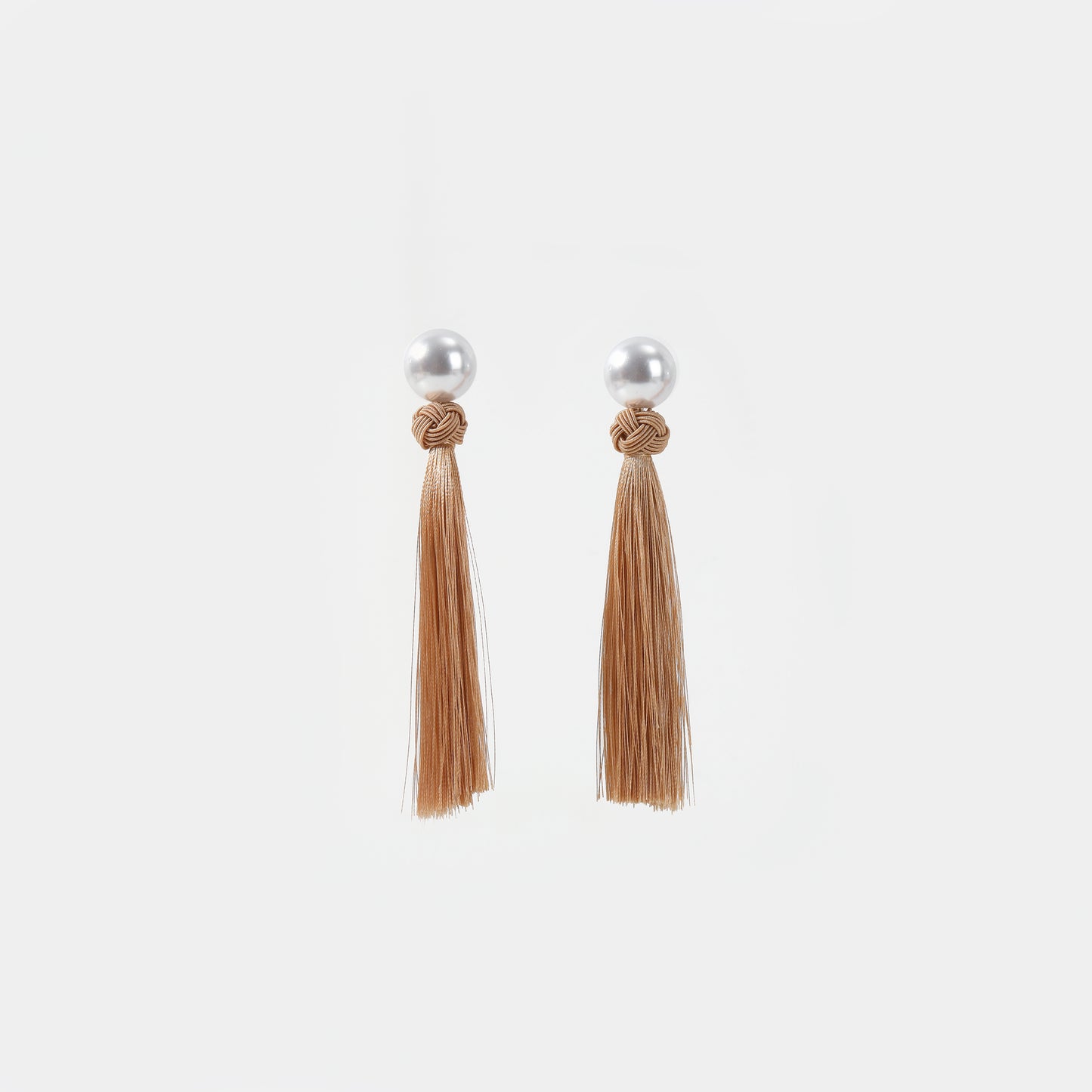 White pearl with light tan knotted tassel drop earrings