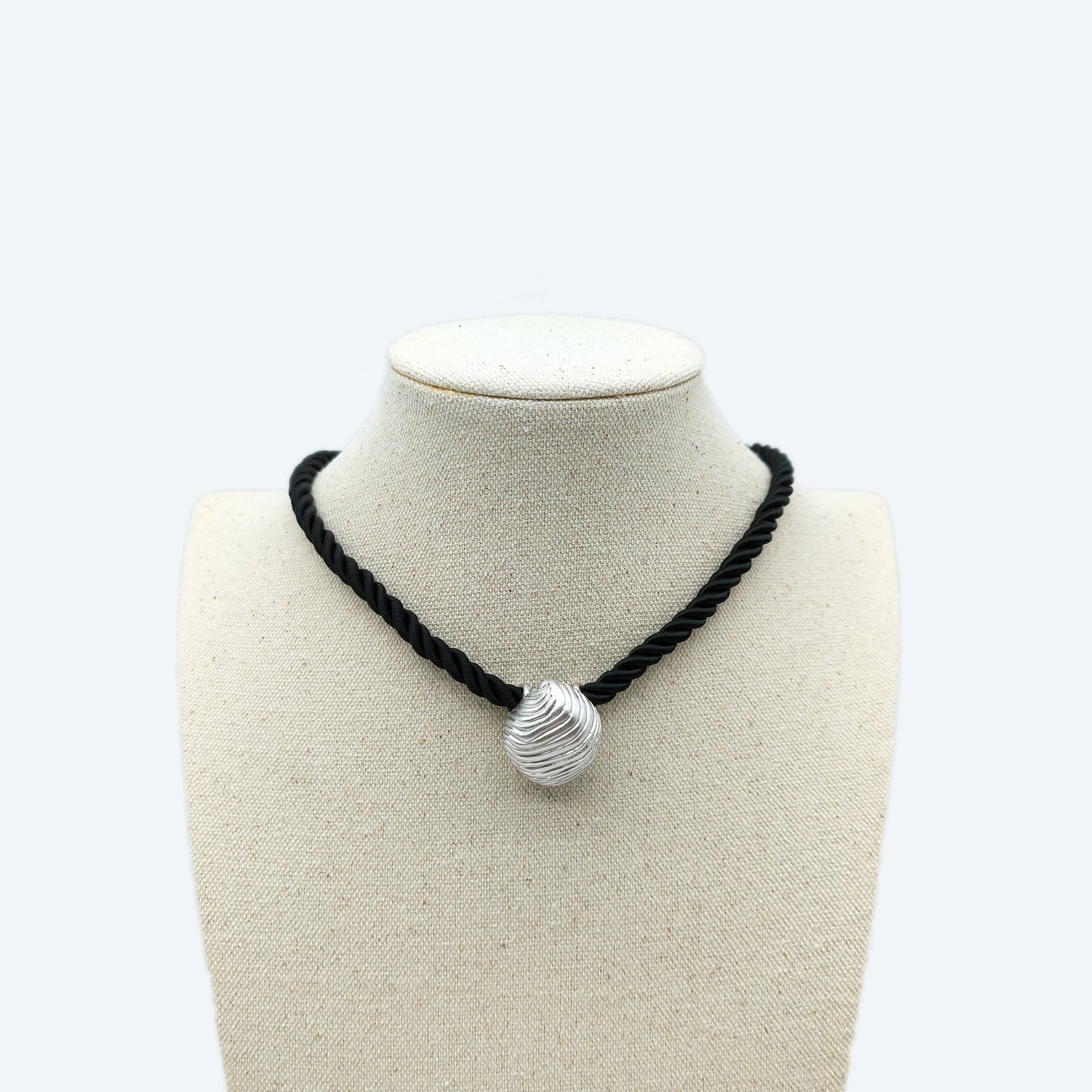 Black rope necklace with silver textured pendant