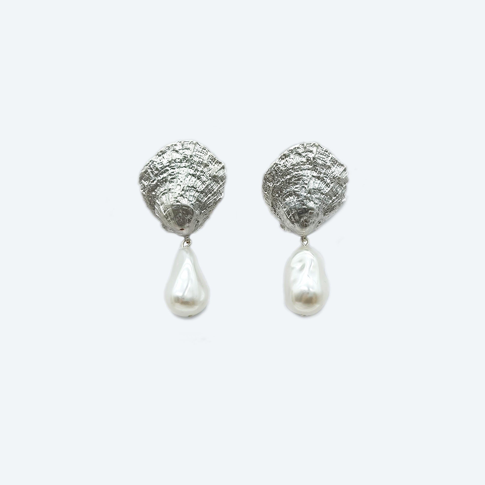 Rhodium metal shell with organic pearl dangle earring