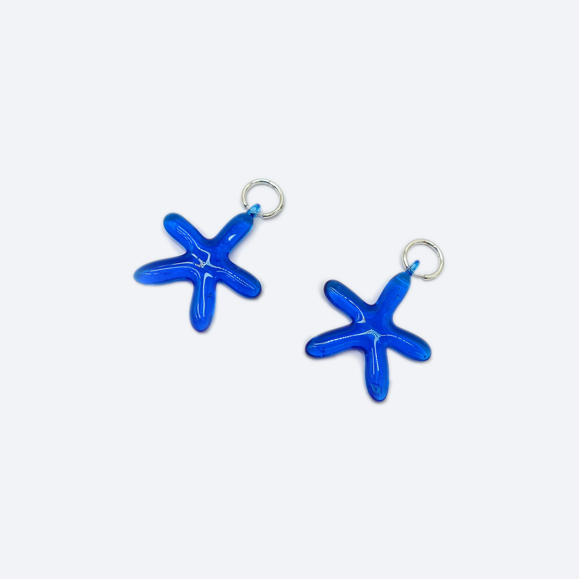 Silver tiny hoop earrings with big solid blue glass starfish earrings