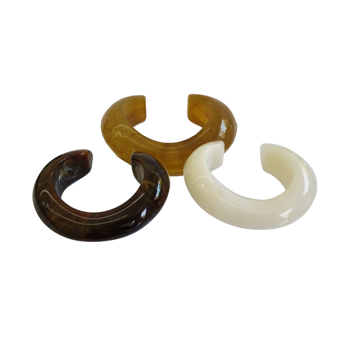Brown, Yellow - brown, and Cream - colored Resin Cuff Bracelets