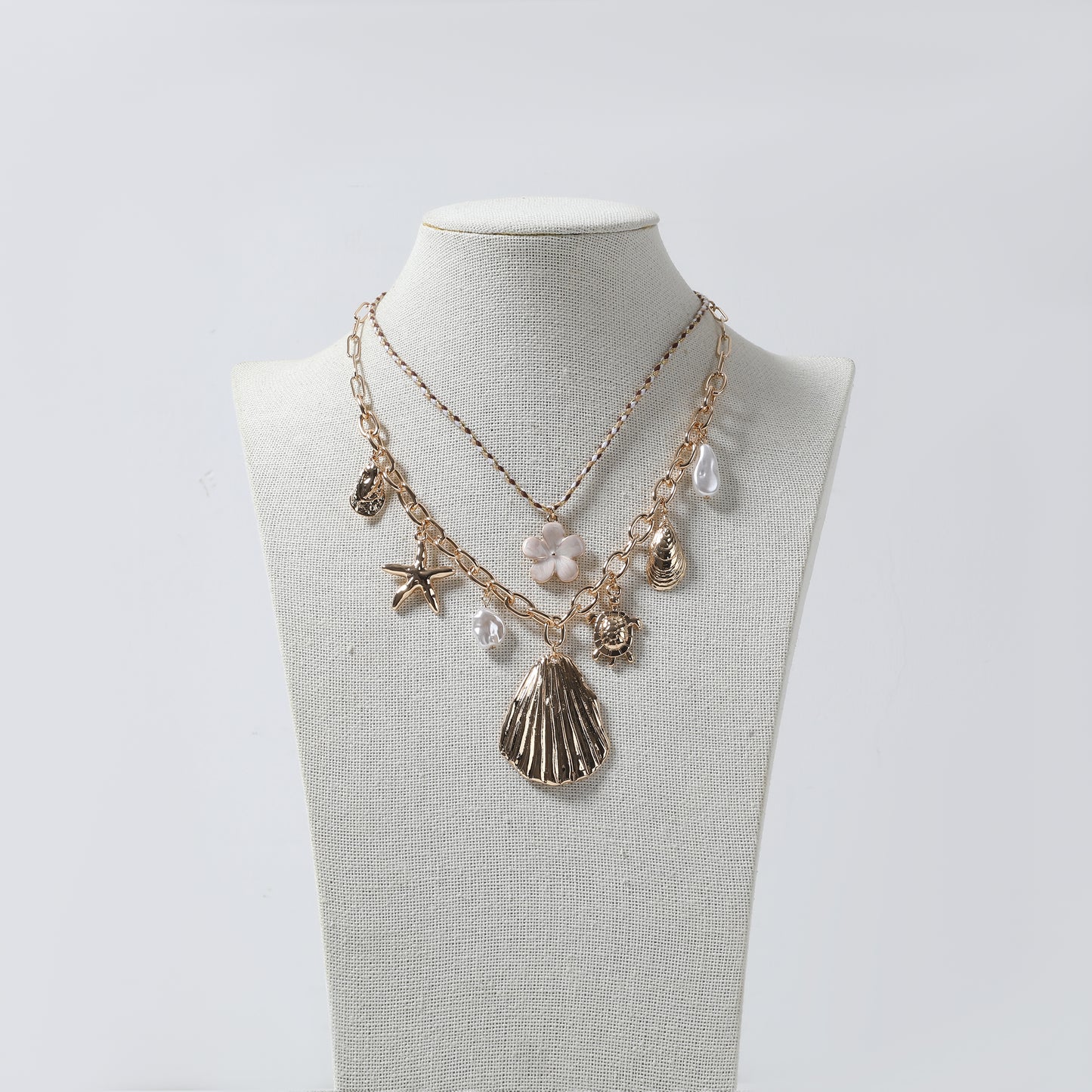 Gold Multi-Layer Sea Life Charm Necklace with White Flower