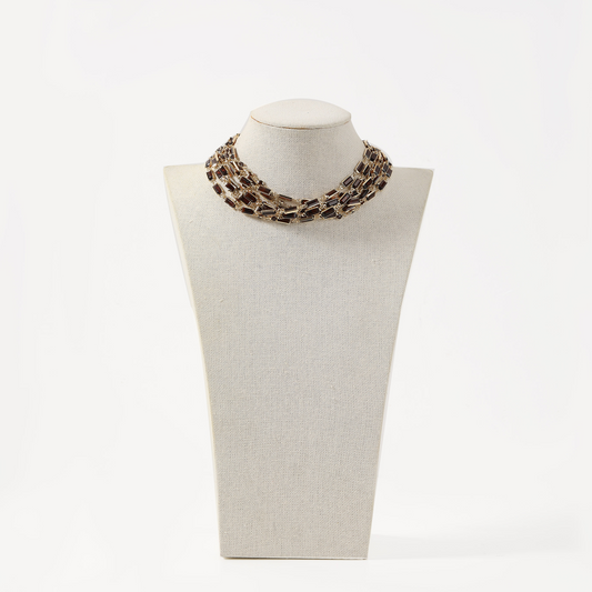 Gold multi-strand choker necklace with brown rectangular crystals.