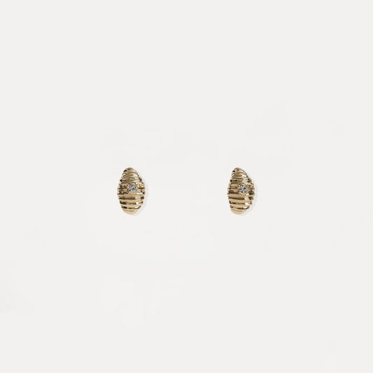 Gold ribbed oval stud earring with central crystal accent