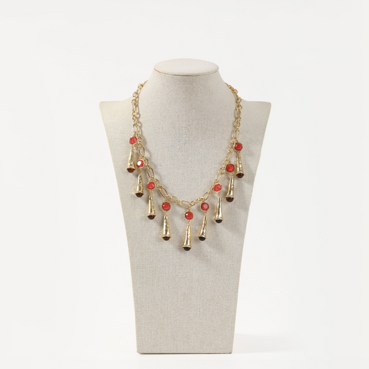 Gold statement necklace with red agate accents and cone-shaped metal fringe
