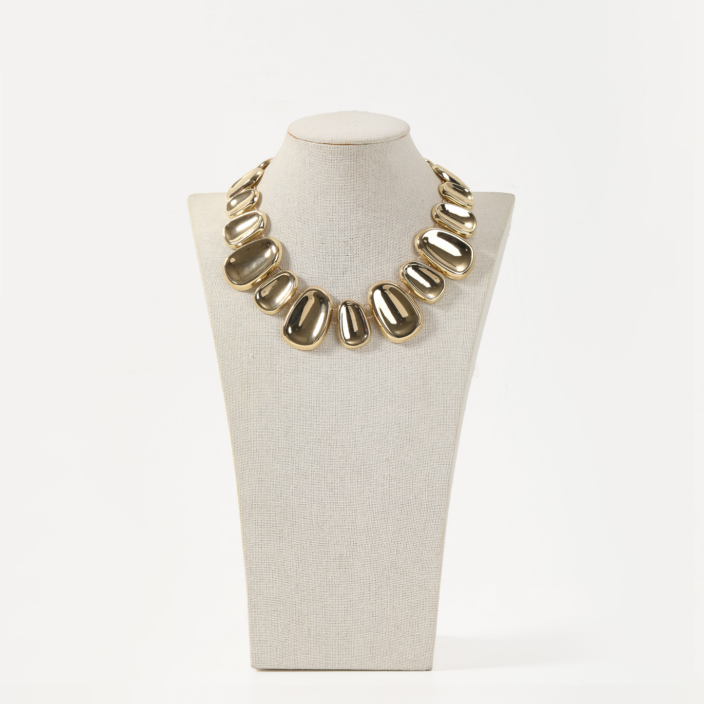 Statement necklace with graduated polished gold pebble links